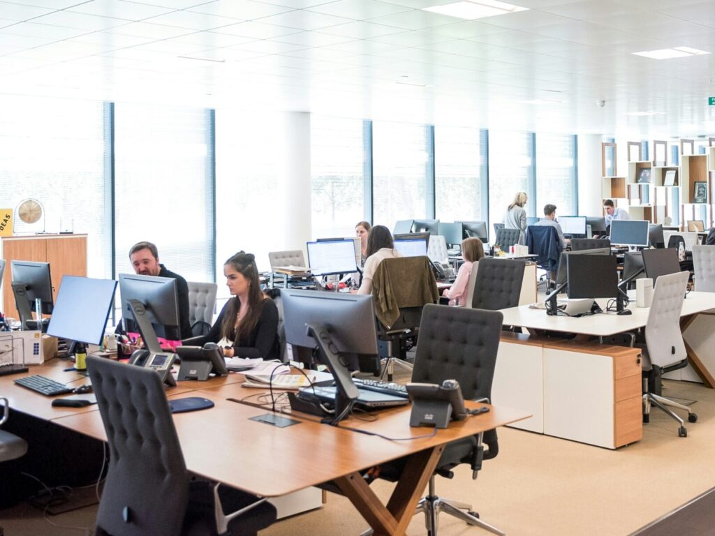 office setting with people working. VerseOne.ai builds AI workflows and AI digital assistants