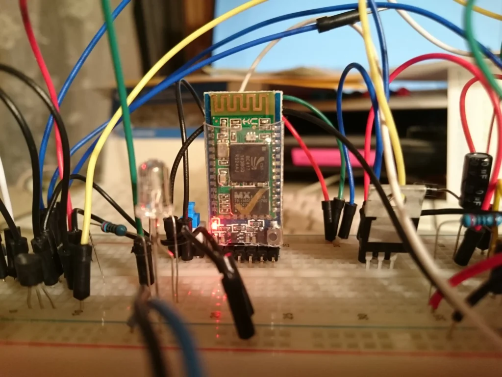 ESP32 Bluetooth module wired to a breadboard with LEDs and components.
