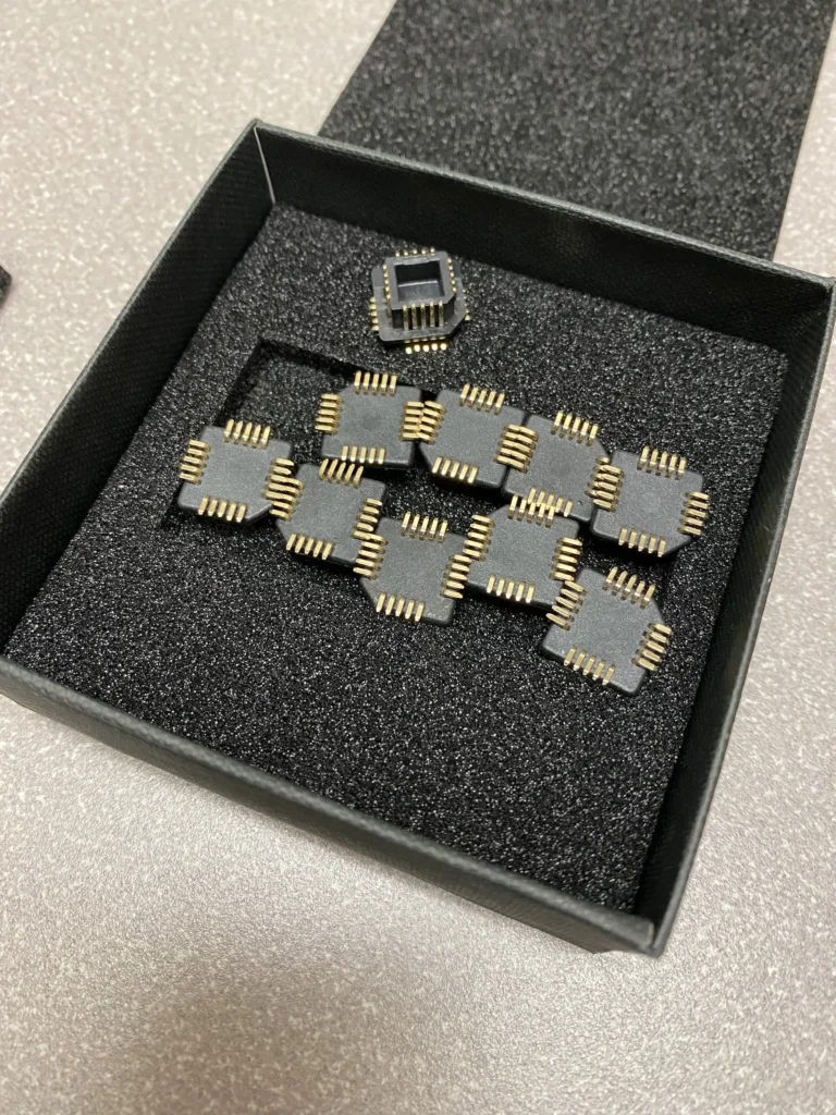 QFN and BGA integrated circuits in a black padded box.