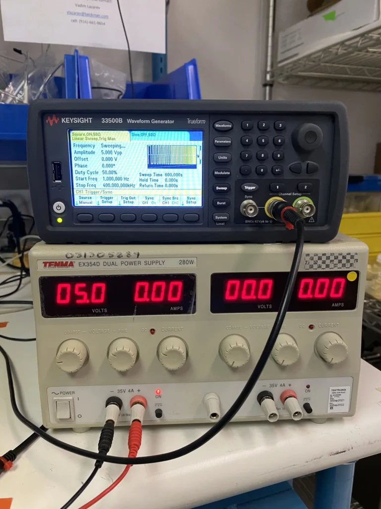 Keysight 3350B waveform generator stacked atop Tenma EX354D dual power supply on a lab bench.